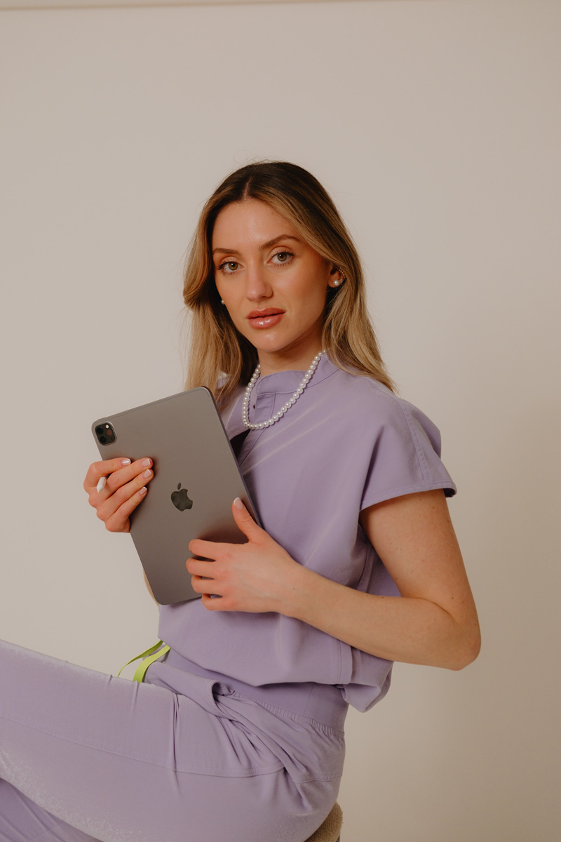 The coach is holding the laptop.